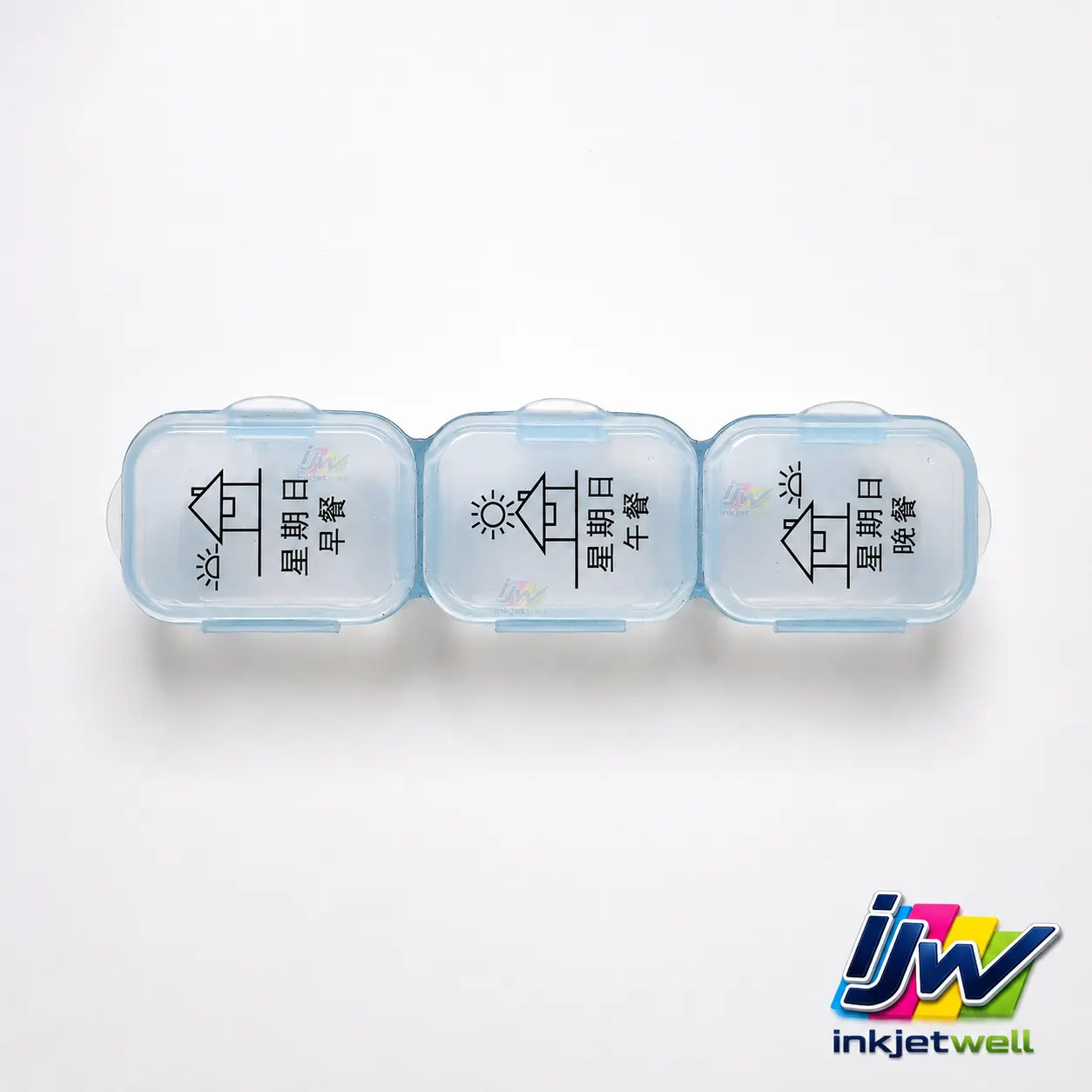 Black breakfast lunch and dinner icons printed on connected transparent plastic pill-box compartments