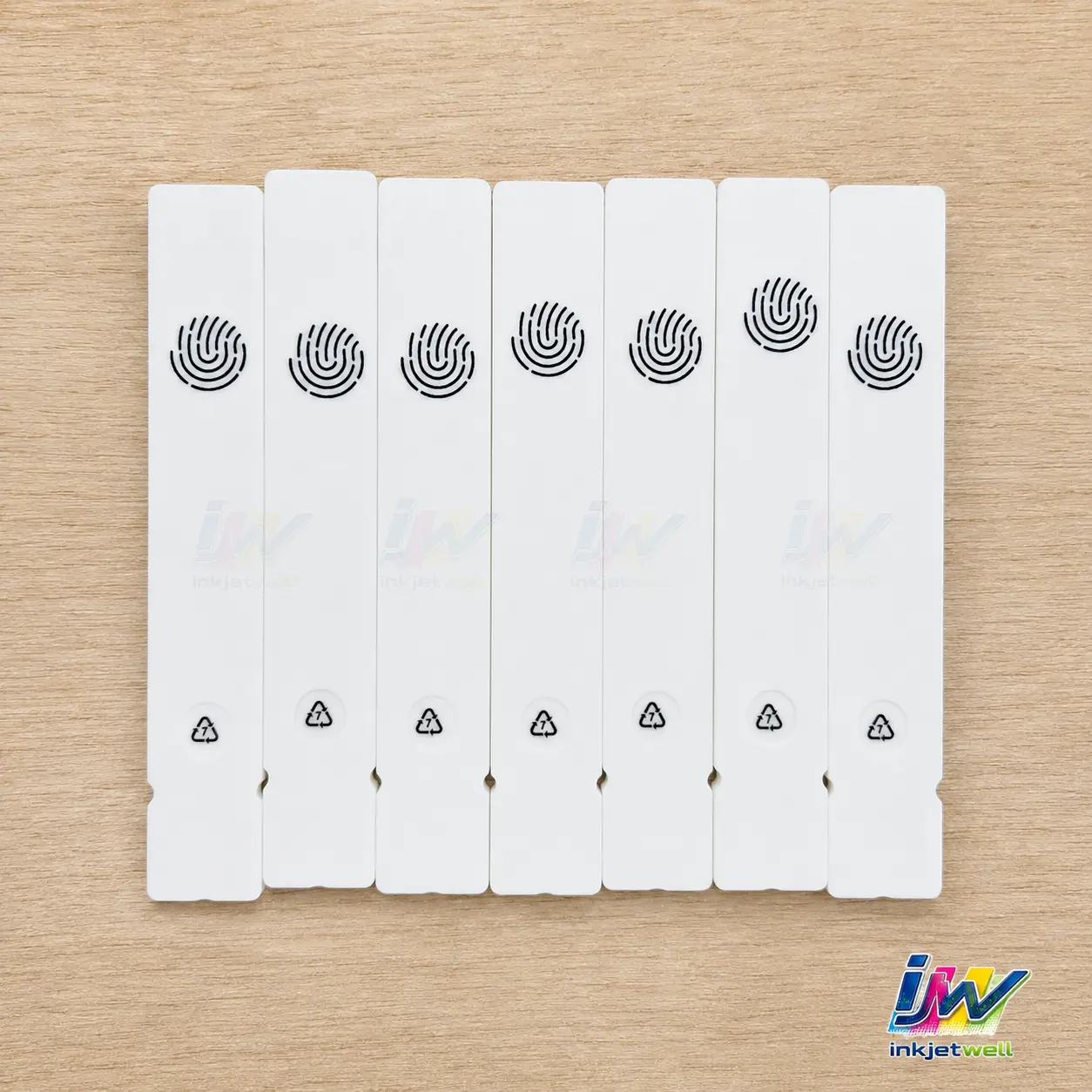 Repeated black icons printed on narrow white plastic components